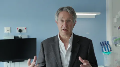 Professor Jonathan Heeney of the University of Cambridge's Lab of Viral Zoonotics speaking in a clinical setting.