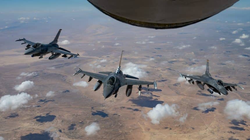 Three US Air Force F-16 Fighting Falcons fly in formation behind a KC-135 tanker over the US Central Command area.
