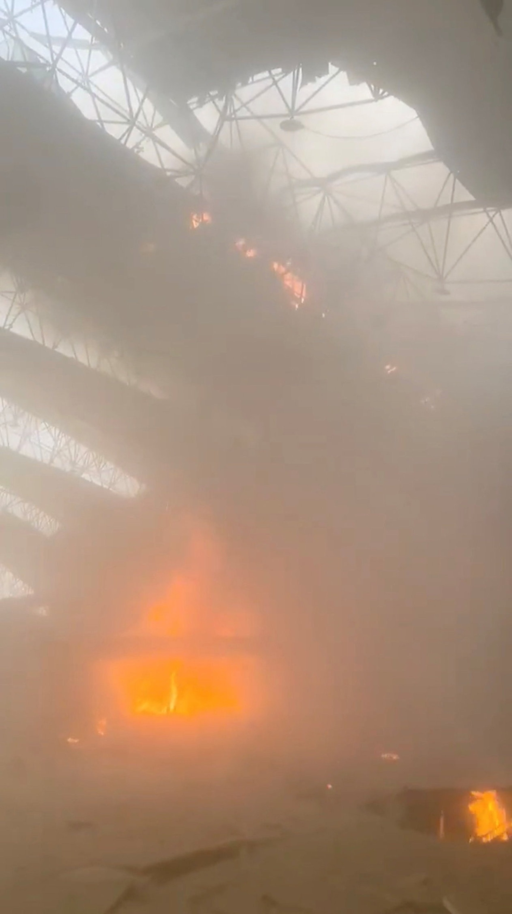 Fire and structural damage inside Kuwait International Airport's Terminal 1 after the strike